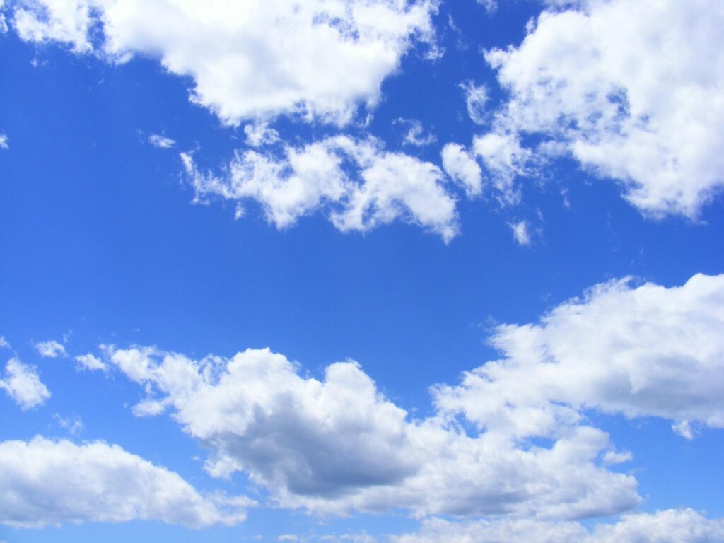 blue-clouds-day-fluffy-53594-53594 Vibrant cumulus clouds adorn a clear blue sky, creating a serene and dreamy cloudscape.